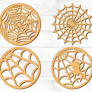May include: Four wooden cutouts of spiderwebs, each with a different design. The cutouts are circular and have a natural wood finish.