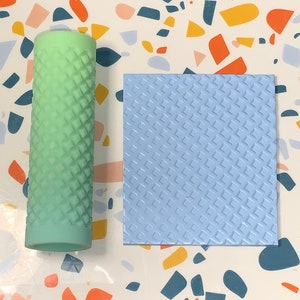 May include: A light blue silicone stamp with a diamond pattern and a green silicone roller with a diamond pattern.