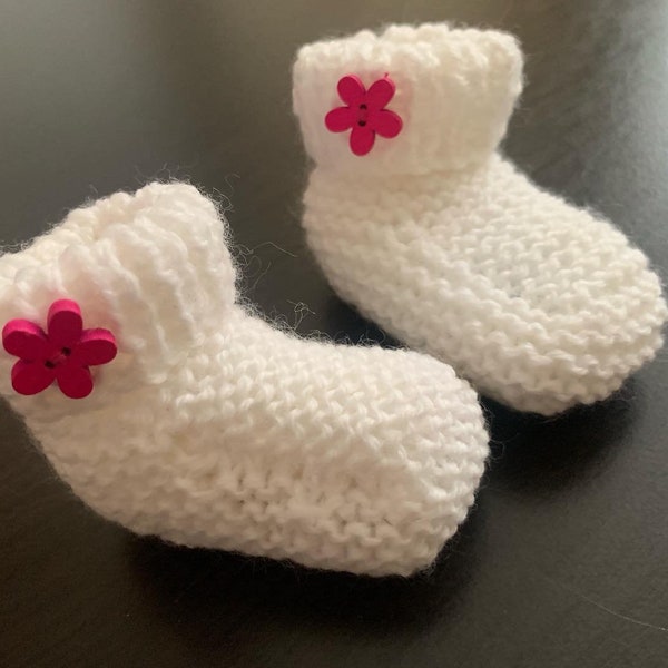 Baby bootees white hand knitted booties with a choice of colour wooden flower button  in sizes from newborn to 12 months