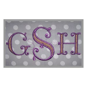 May include: Embroidered monogram with the letters G, S, and H in a decorative script font. The letters are purple with a brown outline and are on a gray background with white polka dots.