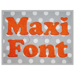 May include: Orange embroidered font that says "Maxi Font" on a gray background with white polka dots.