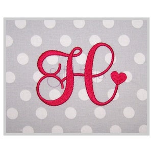 May include: A red embroidered letter "H" with a heart accent. The letter is on a gray background with white polka dots. The design is likely for a monogram or personalized item.