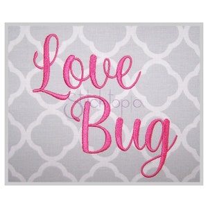 May include: Pink embroidered text on a grey background that reads "Love Bug".