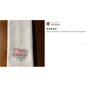 May include: White kitchen towel with red and green embroidery that says "Merry Christmas".