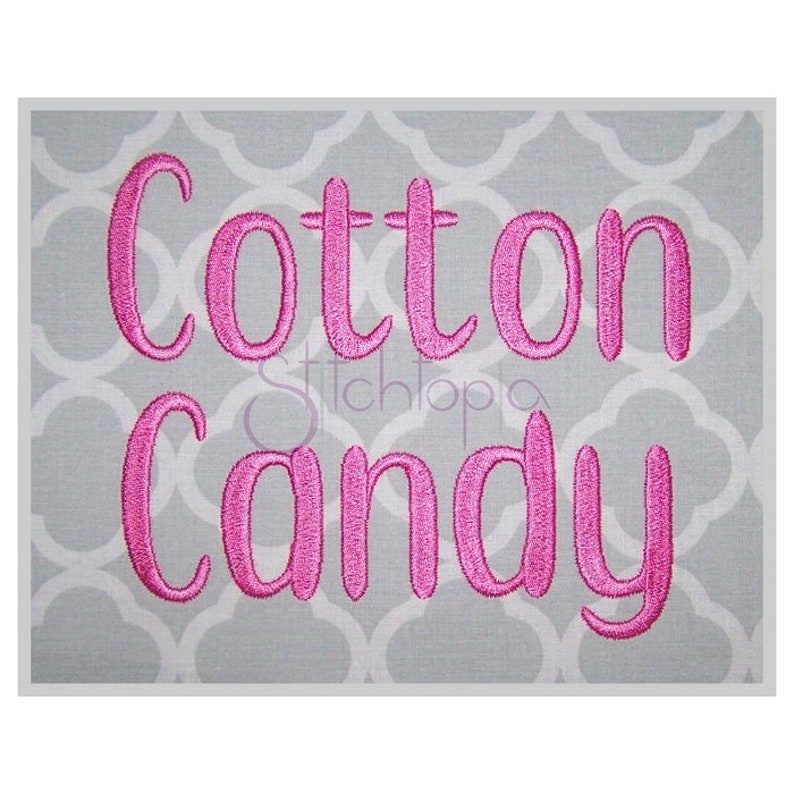 May include: Pink embroidered text on a gray background that reads "Cotton Candy".