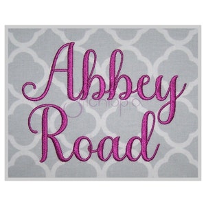 May include: Pink embroidered lettering on a grey background that reads "Abbey Road".