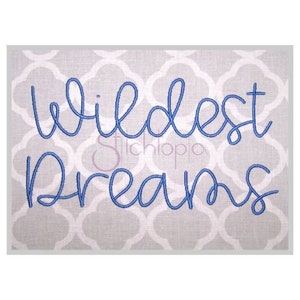 May include: Embroidered design with the text "Wildest Dreams" in a blue cursive font on a gray background.