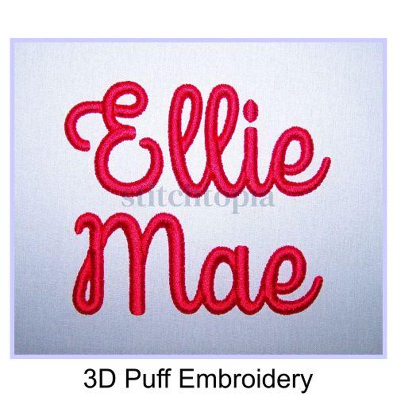 May include: Red embroidered text on a light gray background reads "Ellie Mae" in a cursive font. The words are in a 3D puff embroidery style. The text "3D Puff Embroidery" is below the name.