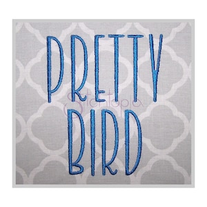 May include: Embroidered design on a gray fabric background. The design is in blue thread and says "Pretty Bird".