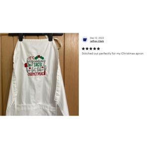 May include: White kitchen apron with red and green embroidery that reads "It's beginning to taste a lot like Christmas".