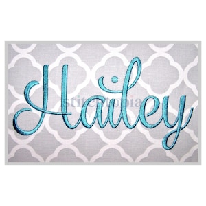 May include: A teal embroidered name "Hailey" in a cursive font, set against a gray and white quatrefoil pattern background. The name is the focal point, showcasing a personalized design.