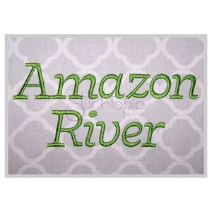 May include: Green embroidered text on a white background that reads "Amazon River".