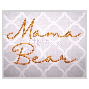 May include: Embroidered design on a white fabric background. The design reads "Mama Bear" in a cursive font.