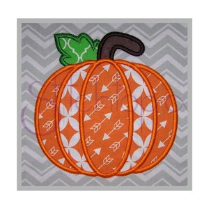 May include: An orange pumpkin with a white and orange patterned design. The pumpkin has a green leaf and a brown stem.