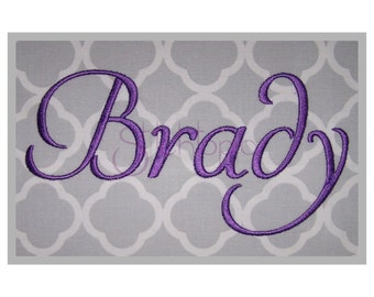 May include: Purple embroidered cursive script name "Brady" on a gray background.
