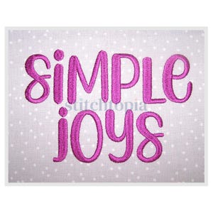 May include: Embroidered design with the text "simple joys" in a pink color on a white background with small pink dots.