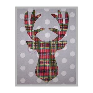 May include: A red, green, and yellow plaid reindeer head silhouette on a white polka dot background.