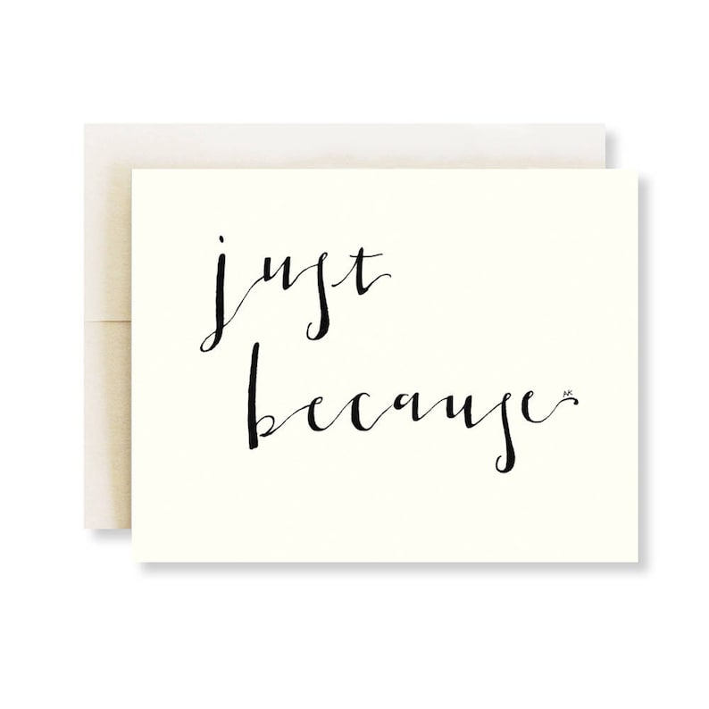 May include: A white card with black calligraphy that reads "just because".