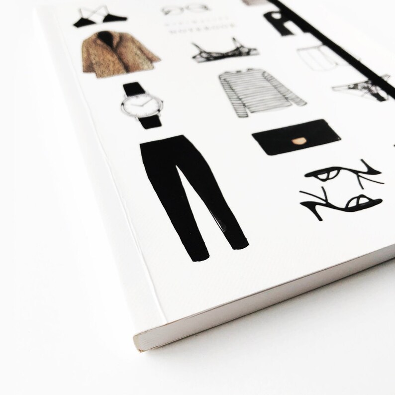 May include: A white notebook with black illustrations of clothing items, including a coat, pants, a watch, a shirt, a bra, a purse, and shoes.