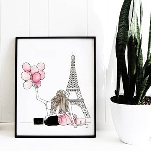 May include: A black and white illustration of two people sitting in front of the Eiffel Tower in Paris, France. The person on the left is holding pink balloons. The illustration is framed in a black frame.