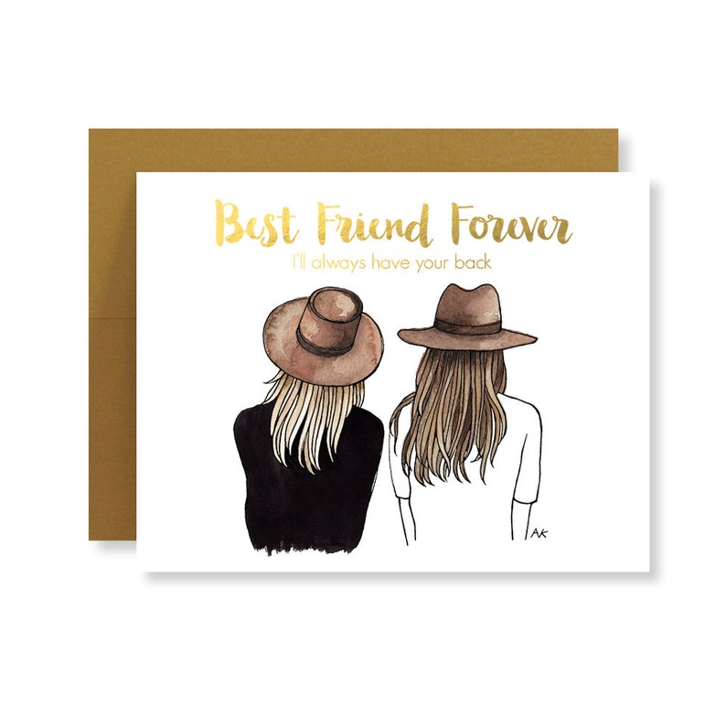 May include: A white card with gold lettering that reads "Best Friend Forever I'll always have your back". The card features a watercolor illustration of two women with long blonde hair wearing brown hats, standing back to back.