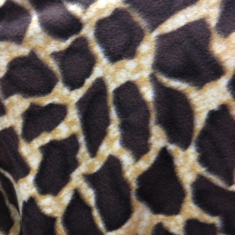 May include: Close-up of a brown and tan fabric with a giraffe print pattern.