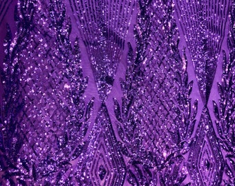 May include: Purple sequined fabric with a geometric pattern. The sequins are arranged in a diamond shape with a floral design.