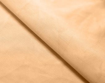 May include: A close-up of a beige tulle fabric with a fine mesh texture. The fabric is soft and delicate, with a subtle sheen.