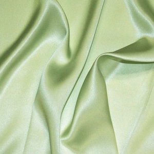 May include: A smooth, light green satin fabric with soft folds and wrinkles.