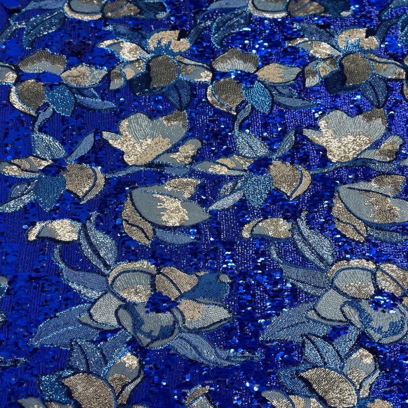 May include: Blue fabric with a silver floral pattern and sequins.