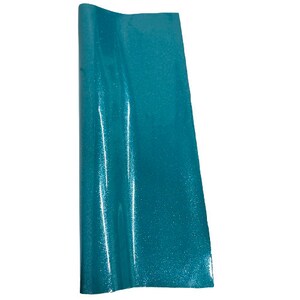 May include: A sheet of teal glitter fabric with a slight sheen. The fabric has a smooth, even texture.