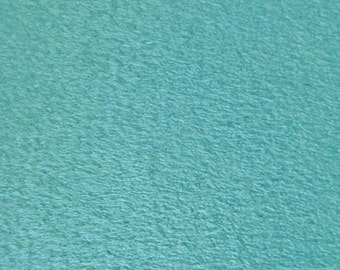 May include: A solid teal blue textured fabric surface.