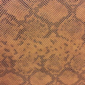 May include: Close-up of a brown textured fabric with a snakeskin pattern.