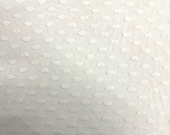 May include: White fabric with a repeating pattern of small, raised oval dots.
