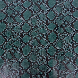 May include: Teal snakeskin pattern fabric with a black background. The pattern is a repeating design of diamond shapes with smaller circles within each diamond.