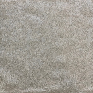 May include: White fabric with an embossed floral pattern. The pattern features intricate swirls and leaves.