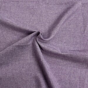 May include: Close-up of a textured, purple fabric with a subtle sheen. The fabric is folded and draped, showcasing its soft and drapey texture.