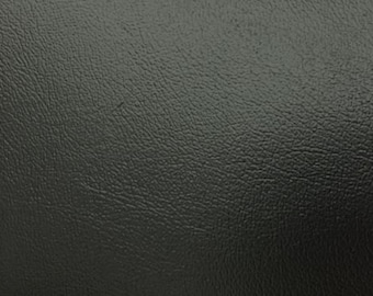 May include: Close-up of a dark gray textured surface that resembles leather.