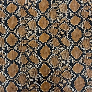 May include: A brown and black snakeskin pattern fabric with a repeating diamond pattern.