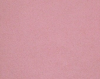 May include: A solid, monochromatic dusty rose pink fabric with a fine, uniform, and slightly granular texture. The surface displays a consistent matte finish across the entire frame, showing no patterns, seams, or additional design elements.