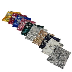 May include: A collection of 10 sequined clutches in various colors, including silver, gold, white, blue, green, pink, red, and yellow. The clutches are arranged in a row, with the silver clutch at the bottom and the yellow clutch at the top.