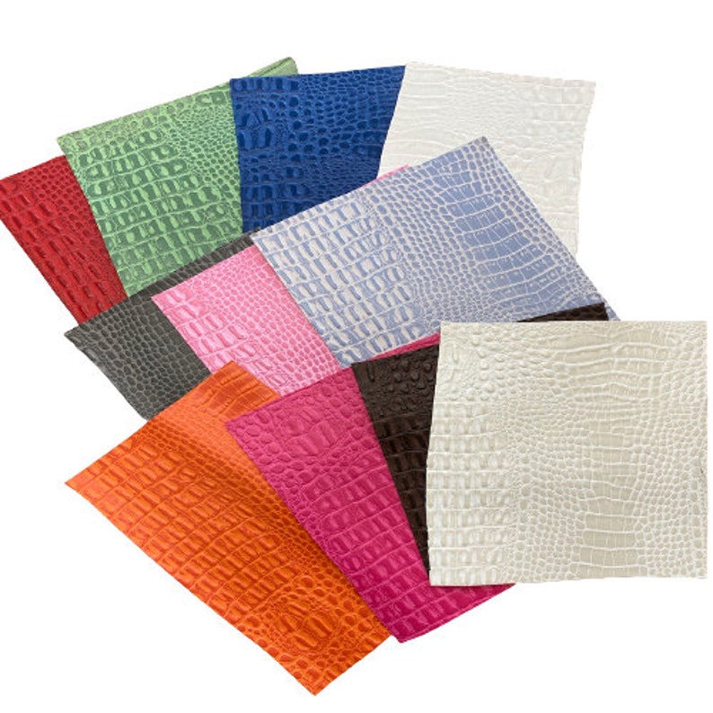 May include: Assortment of faux leather sheets in various colors, including red, green, blue, pink, orange, and white. Each sheet features an embossed crocodile pattern.