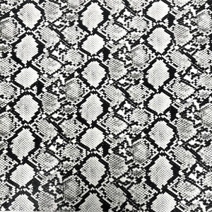 May include: Black and white snake skin pattern fabric. The pattern is a repeating diamond shape with a textured look.