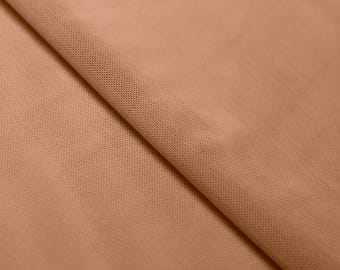 May include: A close-up of a light brown sheer fabric with a fine mesh texture.