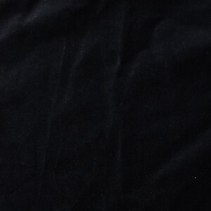 May include: Black velvet fabric with a smooth, soft texture.