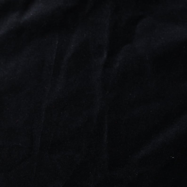 May include: Black velvet fabric with a smooth, soft texture.