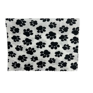 May include: White fabric with a black paw print pattern.