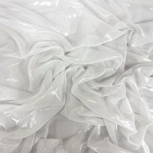 May include: A close-up of white, shimmering fabric, with folds and creases creating a textured effect. The material appears to be lightweight and possibly translucent, with a subtle sheen. The fabric is likely suitable for clothing or decorative applications.