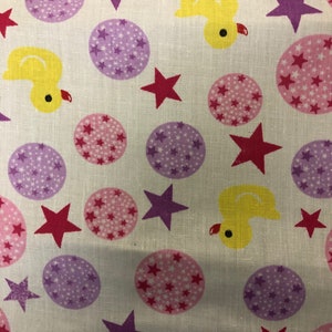May include: A repeating fabric pattern with yellow ducklings, pink and purple star-filled circles, and red stars on a white backdrop. The design is playful and suitable for children's items or nursery decor.