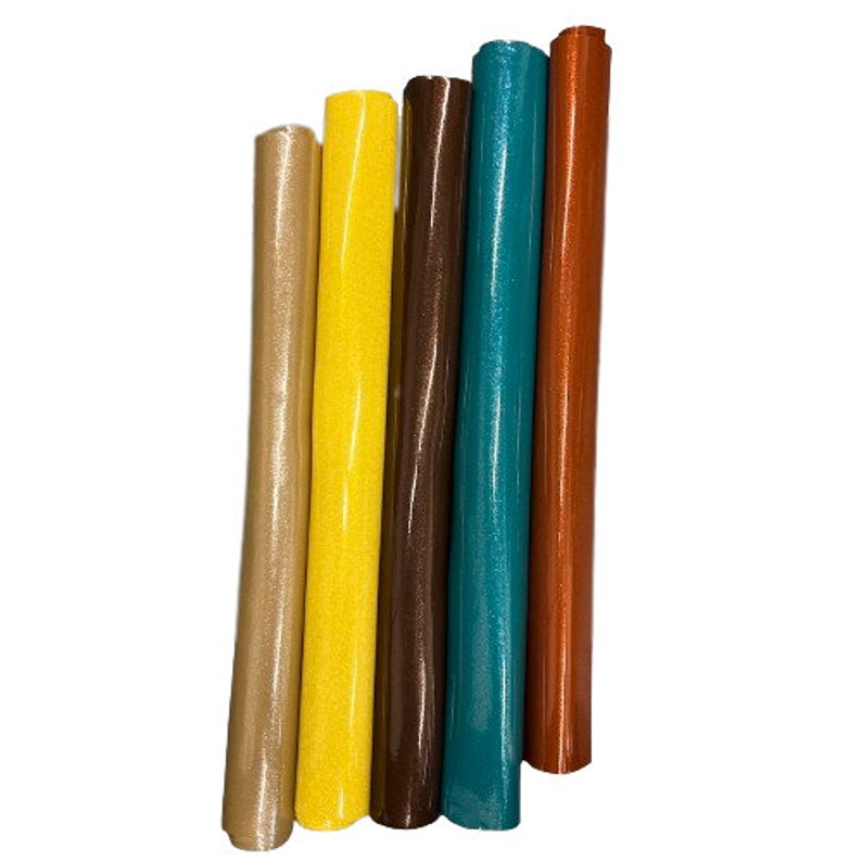 May include: Five rolls of glitter fabric in different colors: gold, yellow, brown, teal, and orange.